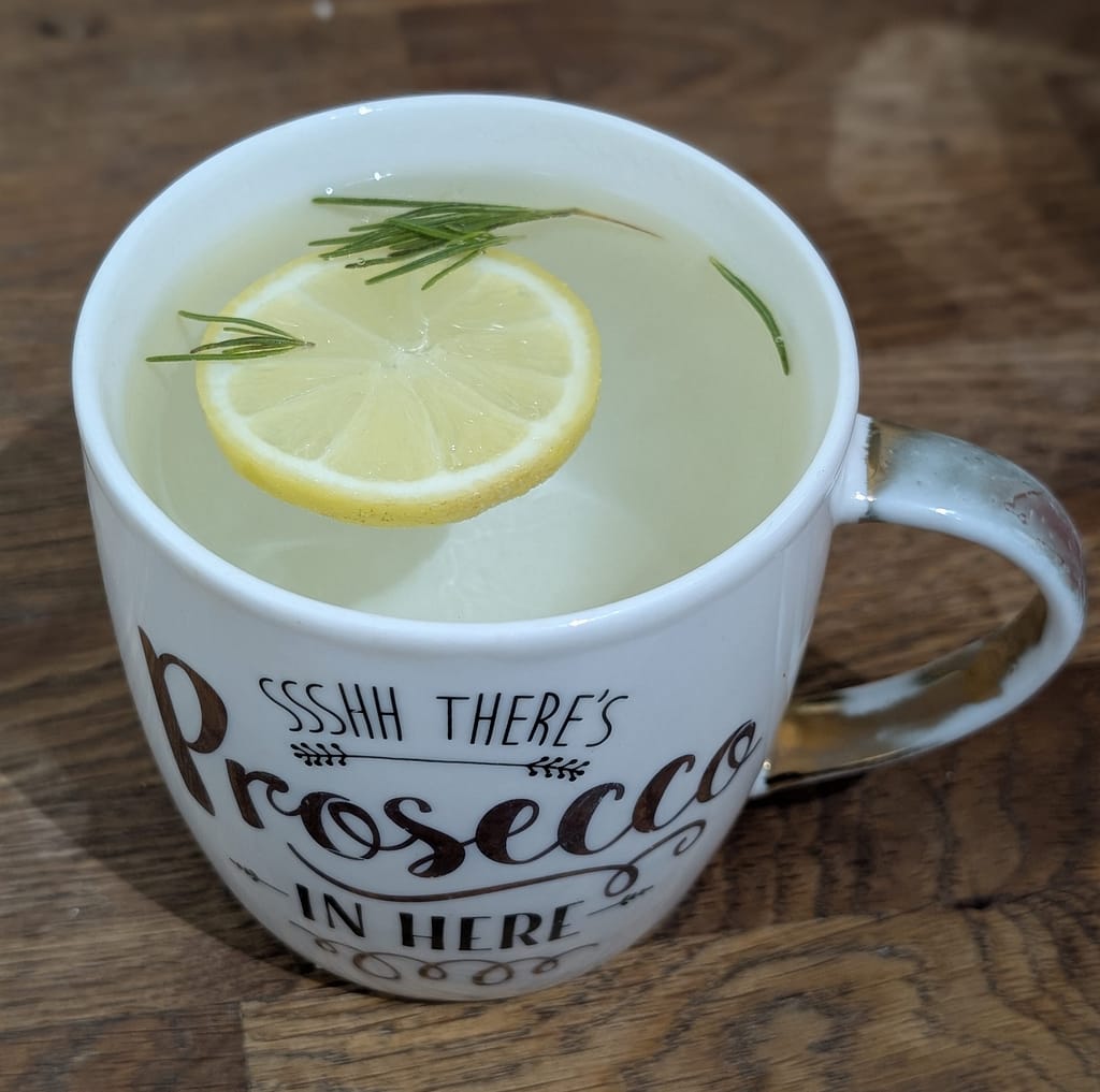 Lemon and rosemary drink in china mug during midlife metabolic mutiny