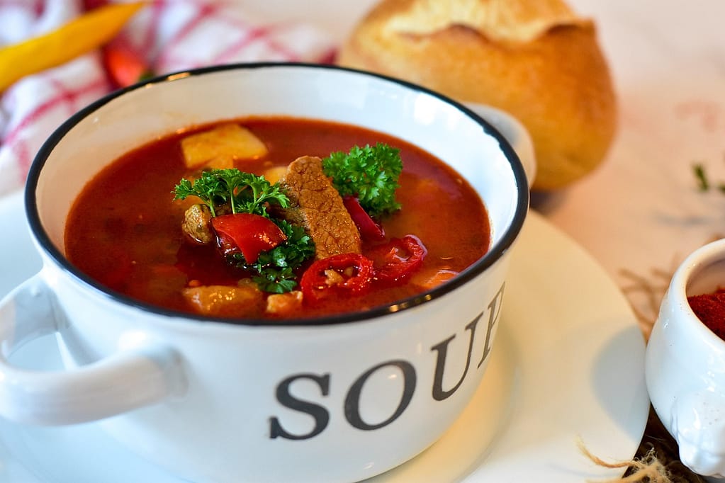 A bowl of homemade soup with beef, red peppers, and parsley — a comforting, nourishing meal for Mental Health Day 2025.